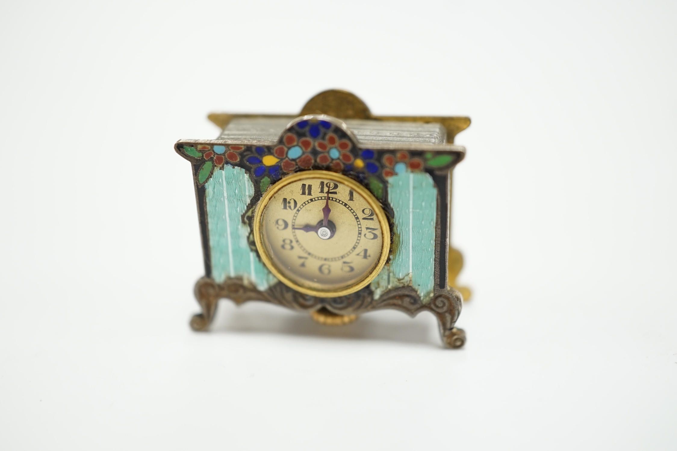 A miniature enamel timepiece modelled as a mantle clock, with watch movement, 2cm high, in fitted case